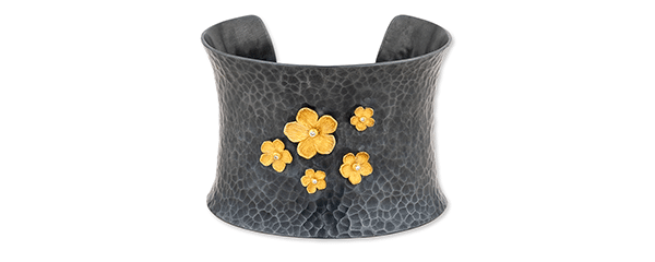 Black and gold flowered bracelet cuff.